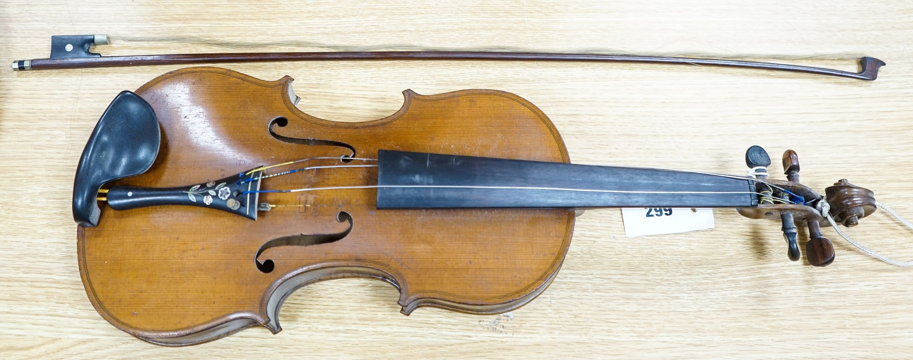 A violin labelled Francesco Ruggeri and a bow. Back of violin excluding button - 36cm